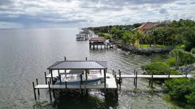 Waterfront dock with covered boat lift on Melbourne Florida shoreline
